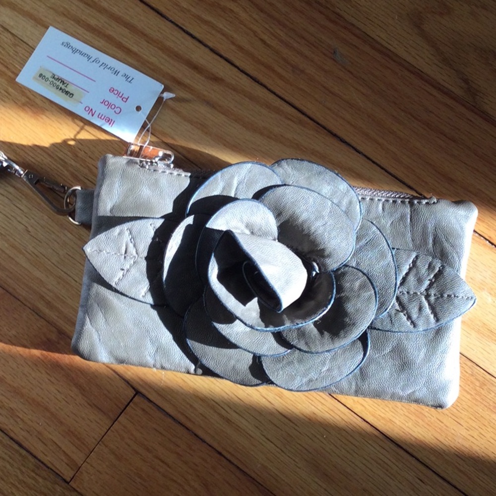 Small clutch purse.  Taupe with decoration.